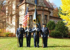 4 members of the Honor Guard in front of a large building